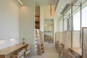 Interior of a modern office workspace featuring compact design and wood materials.