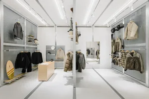 Modern retail interior with metallic display featuring clothing items.