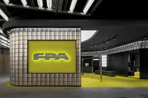 A modern retail space featuring metal tiles on the wall.
