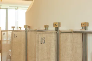 Textured fabric cubicle dividers mounted on metal rods.