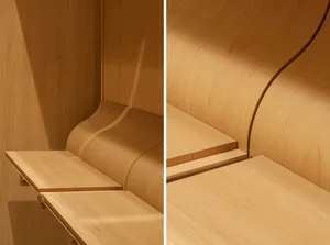 A close-up view of a curved wooden storage unit with an integrated shelf.