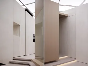 Modern minimalist interior with concrete walls and floor, featuring clean lines and a sleek design.
