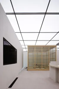 A modern office space featuring glass floor and ceiling panels.