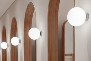 Modern interior design featuring minimalist lighting fixtures and wooden panels.