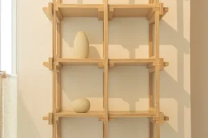 Modern interior design with a wooden shelving unit featuring geometric patterns and simple decor.