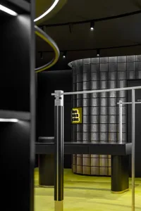 A sleek, modern retail display featuring metallic surfaces, glass panels, and illuminated neon elements.