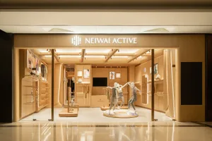 A modern retail storefront with wooden interiors and overhead lighting.