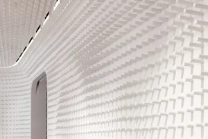 A modern white interior design with a textured plastic wall pattern