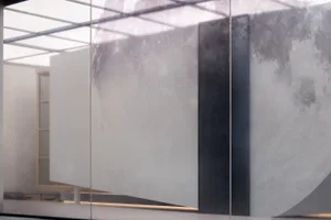 A modern interior space featuring a glass panel wall