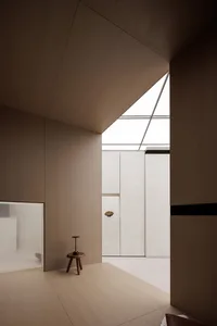 Minimalist interior design featuring warm-toned wood elements.