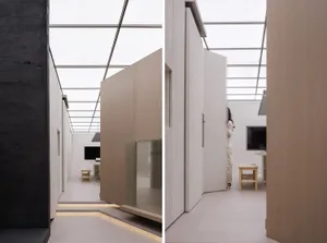 A minimalist interior with wooden panels and a glass wall.