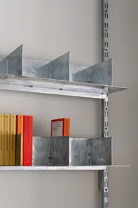 Industrial-style metal shelving unit with books and dividers.