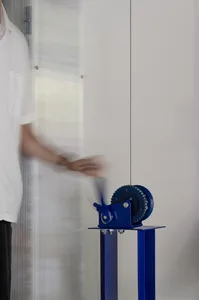 A minimalistic mechanical engineering machine with blue metal components.