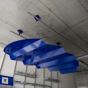 A minimalist interior design featuring blue, geometric metal sculptures