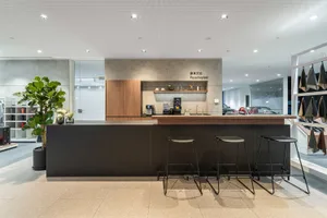 Modern coffee shop with minimalist design and concrete counter.