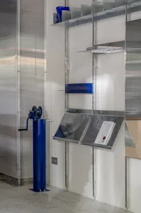 A modern installation featuring metallic shelving and reading stands