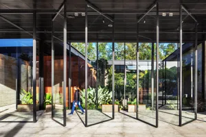 Modern interior design featuring glass, concrete, and wood materials.