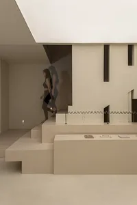 Minimalist interior space with neutral tones and geometric shapes.