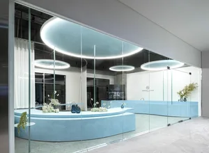 A minimalist interior space featuring blue concrete and glass elements.