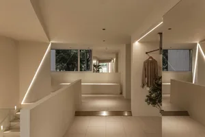 An industrial-style, modern interior space with concrete finishes and large windows.