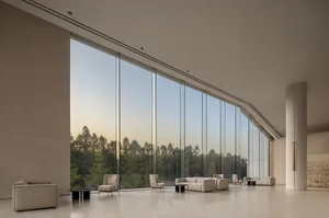 Modern lobby with large glass windows and minimalist furniture.