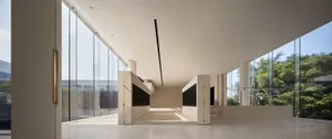 A modern lobby with a glass facade, clean lines, and minimalistic design.