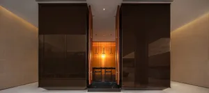 A modern lobby featuring glass and wooden elements.