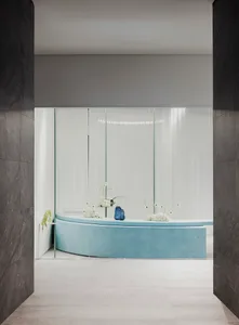 A modern reception desk made from blue leather with floral arrangements.