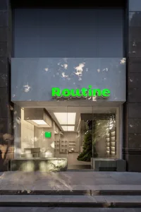 Modern retail storefront with concrete and glass elements.