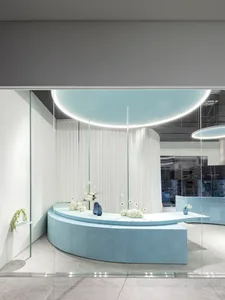 A modern retail storefront featuring glass and concrete elements.