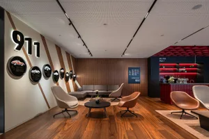 Modern retail storefront featuring wood paneling, leather furniture, and metal accents
