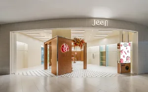 Jeen storefront with modern design elements, including tile flooring, wooden accents, and glass displays.