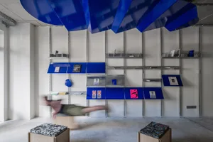 A modern bookshop design featuring a metal shelving system.