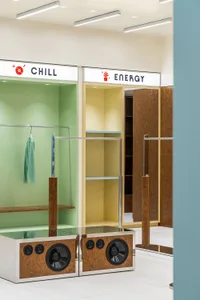 Modern clothing retail store featuring metal shelves and clothing racks.