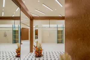 A modern clothing shop featuring wood paneling and clean lines.