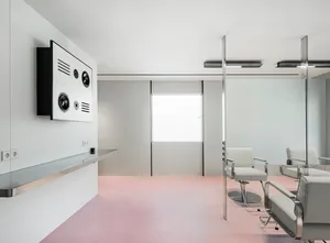 A minimalist, white-painted hair studio with contemporary design elements.