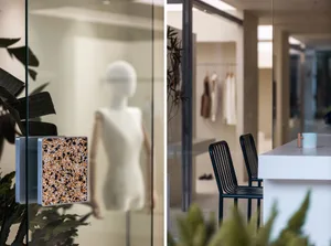 A modern office space featuring glass walls and contemporary interior design elements.