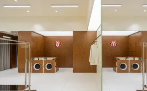 Modern retail interior with wooden clothing shop, featuring brown wooden walls and white floors.