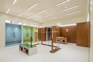Modern clothing shop with colorful sections and wooden fixtures