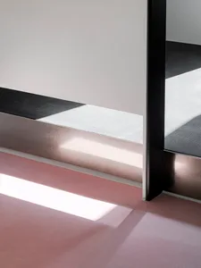 Modern floor with metal frame reflecting sunlight and shadow.