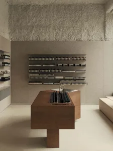 A minimalist retail space featuring wooden tables and metal shelving.