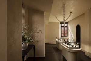 A minimalist interior with a modern display case featuring concrete and glass materials.