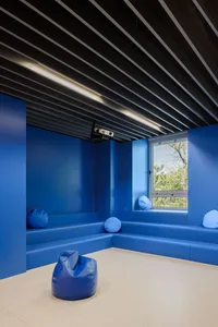 Modern education space with blue walls and seating area.