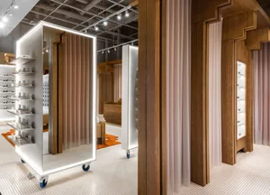 Modern eyewear store with metal, glass, wood, and silk materials