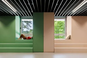 A minimalist interior design featuring soft pastel colors and natural light entering through windows.