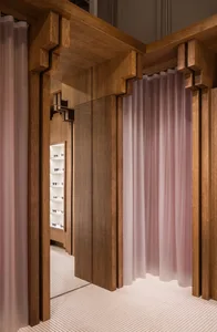 Modern retail store with wooden display and frosted curtains