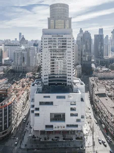 A high-rise building made of modern materials in an urban setting.