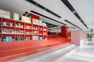 A modern bookstore interior with prominent red shelving.