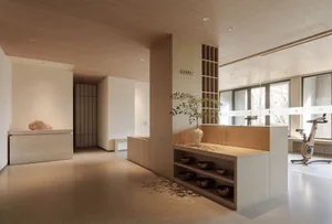 簡約風格的健身房，鋪設木地板，擺放一盆植物與一台固定式腳踏車。
