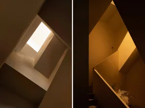 A concrete staircase with a skylight illuminating the space.